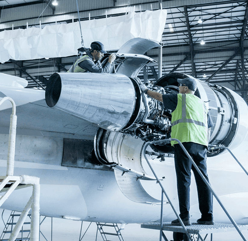 Manny and Jose Encinas working on an aircraft engine